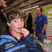Joseph Hippisley tries out an edible salted locust on the Bugvita stall from Blankney at Lincolnshire Food and Gift fair.