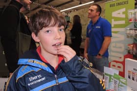 Joseph Hippisley tries out an edible salted locust on the Bugvita stall from Blankney at Lincolnshire Food and Gift fair.