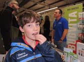 Joseph Hippisley tries out an edible salted locust on the Bugvita stall from Blankney at Lincolnshire Food and Gift fair.