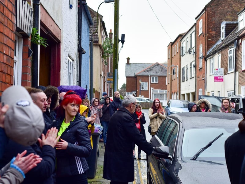 Adi's friends clap as his coffin arrives for the funeral procession