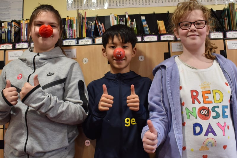 Supporting Comic Relief with Red Nose Day noses and a Red Nose Day t-shirt, a trio from Boston's Staniland Academy.