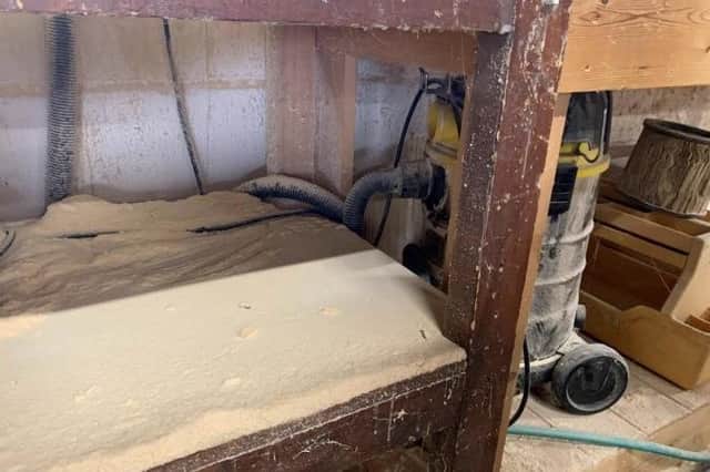 Accumulated wood dust below the chop saw at The Furniture Chest workshop in Heckington. Photo: HSE