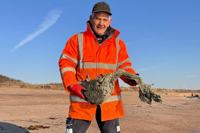 Derrick Whitworth from ELDC  Street Scene on Skegness beach viewing the debris.
