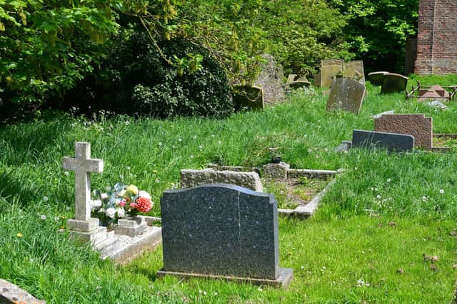 Flowers left on one of the graves at St Peter's Church, in Midville.