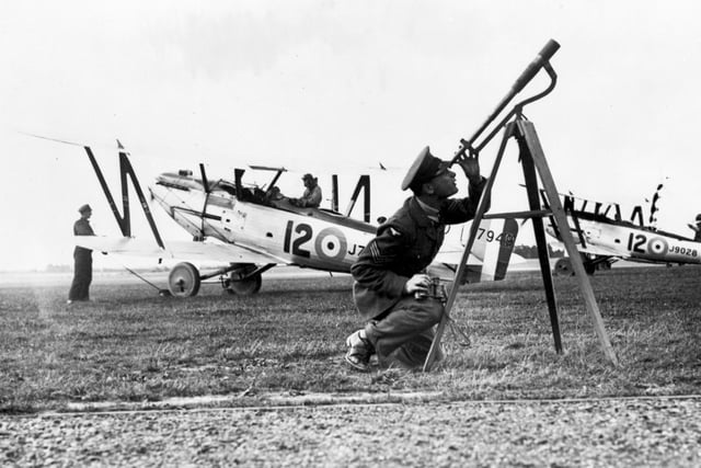 RAF Andover, Hampshire based 12 Squadron Fairey Foxes J7949 and J7950 with a Sergeant checking the Met with a telescope. The squadron was the only RAF user of the Fairey Fox, 1926-31, and its performance was superior to other types, resulting in the motto of 'Leads the Field'. Photo: RAF Air Historical Branch