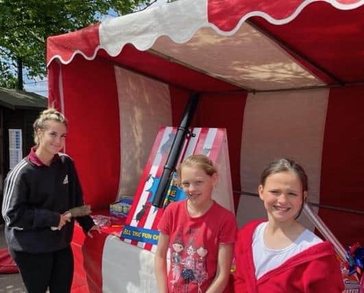 Theddlethorpe Academy pupils, Elissia Alan (Year 4) and Izzy Alan (Year 6) enjoy the fairground stalls at the Jubilee party.