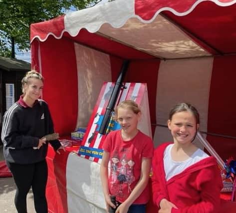 Theddlethorpe Academy pupils, Elissia Alan (Year 4) and Izzy Alan (Year 6) enjoy the fairground stalls at the Jubilee party.