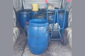 The 12 container drums police found in the back of the van.