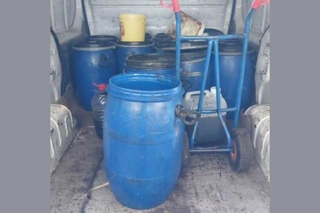 The 12 container drums police found in the back of the van.
