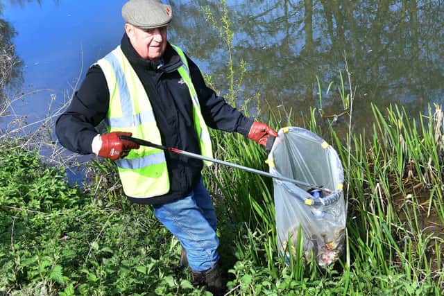 Roger Waite picking cans out of River Waring for Horncastle Rivercare. Photos: Mick Fox