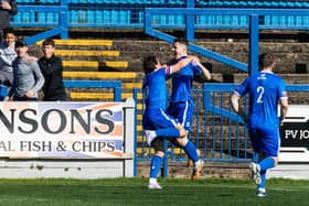 Lewis Butroid celebrates putting 10-men Trinity in front on Saturday.