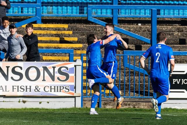 Lewis Butroid celebrates putting 10-men Trinity in front on Saturday.