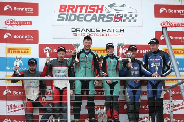Todd Ellis and Emmanuelle Clement (centre) on the podium after their title win. Photo: David Yeomans.