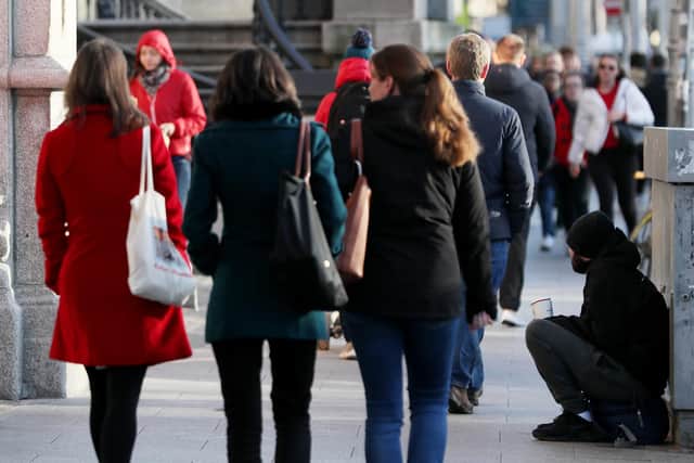 A homeless man begging on the streets of Dublin.