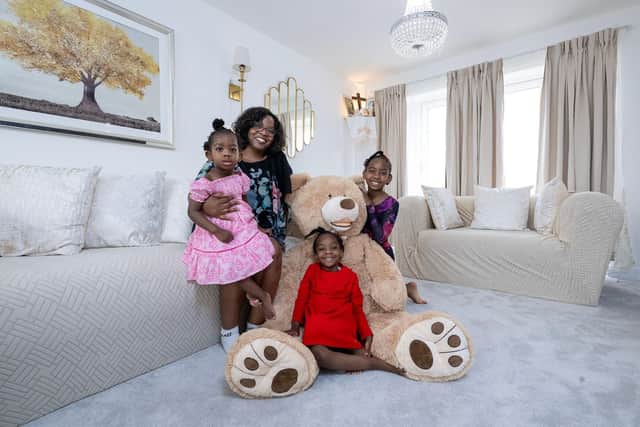 Tess Ilogu and her daughters, ChimChim, SomSom, and Zizi, inside their Bellway home at Pinchbeck Fields in Spalding
