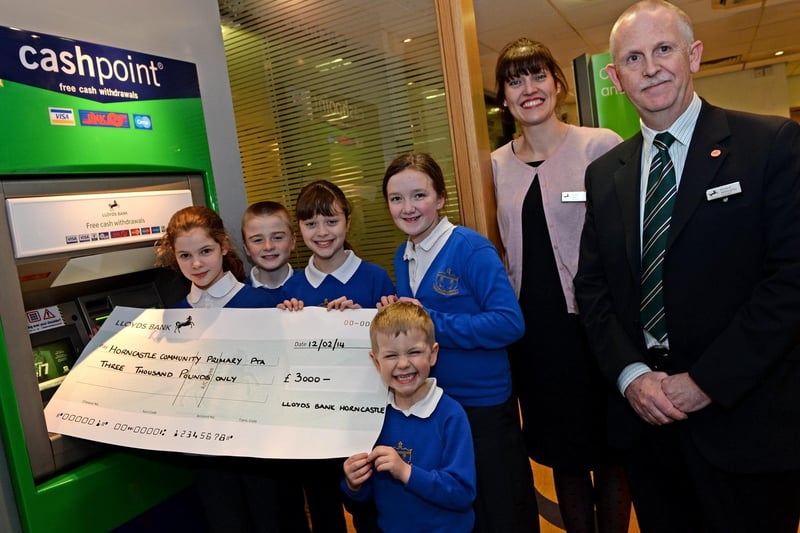 Pupils from Horncastle Primary School receiving £3,000 for the Parent and Teacher Association (PTA) through the Lloyds Bank Community Fund. Customers at the Horncastle branch of Lloyds had been asked to select a local good cause to receive support and the PTA had come out on top.