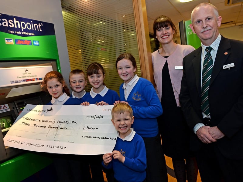 Pupils from Horncastle Primary School receiving £3,000 for the Parent and Teacher Association (PTA) through the Lloyds Bank Community Fund. Customers at the Horncastle branch of Lloyds had been asked to select a local good cause to receive support and the PTA had come out on top.