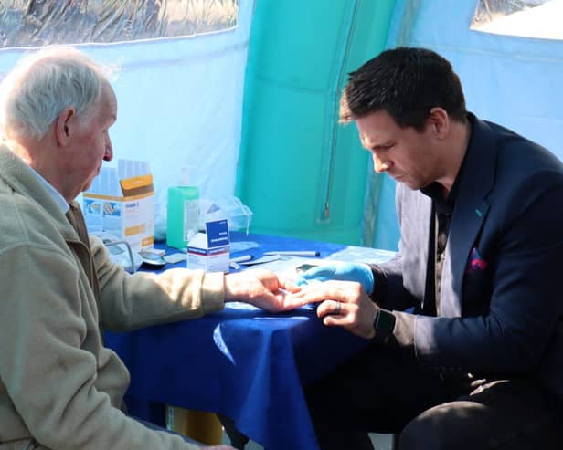 Steve Roest conducting a heart health test at a Lincolnshire Co-op health pod event
