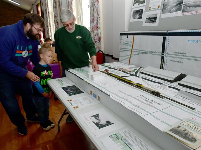 Gareth Evans and Wyatt Evans, six, of Sleaford with club secretary Colin Houseman, with a representation of RAF Cranwell station.