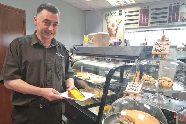 Coun Danny Brookes serving cakes at his Indulgence cafe.