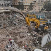 Rescue personnel search for victims and survivors through the rubble of buildings in Kahramanmaras, the day after a 7.8-magnitude earthquake struck the country's southeast, on February 7, 2023. (Photo by ILYAS AKENGIN/AFP via Getty Images)