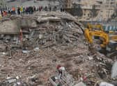 Rescue personnel search for victims and survivors through the rubble of buildings in Kahramanmaras, the day after a 7.8-magnitude earthquake struck the country's southeast, on February 7, 2023. (Photo by ILYAS AKENGIN/AFP via Getty Images)