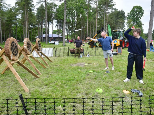 Brian Parkinson and Freya Parkinson of Louth, axe throwing, watched by Jim Milner of Wilderness Ways, Tattershall. Photo: David Dawson