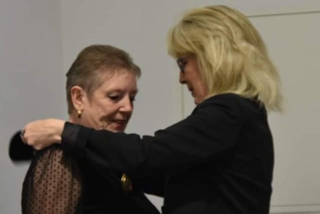 New Mayoress Lin Tye receives the chain of office from outgoing Mayoress Jane Burnham.