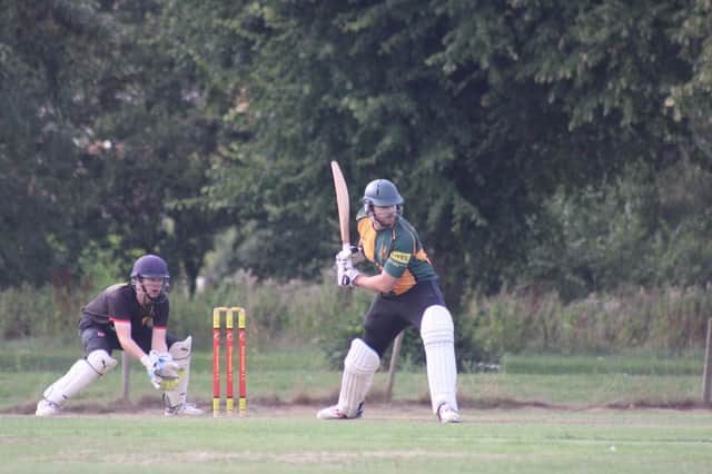 Player of the Match Connor Parsons batting for the Guest XI with Jonny Clark of Horncastle wicket keeping