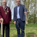 NKDC chairman Coun Mike Clarke(left) and Chief Executive Ian Fytche plant an oak tree on North Hykeham's Millennium Green as the first of 50 to be planted in the authority's 50th year.