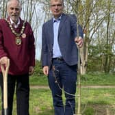 NKDC chairman Coun Mike Clarke(left) and Chief Executive Ian Fytche plant an oak tree on North Hykeham's Millennium Green as the first of 50 to be planted in the authority's 50th year.
