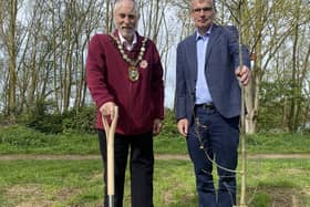 NKDC chairman Coun Mike Clarke(left) and Chief Executive Ian Fytche plant an oak tree on North Hykeham's Millennium Green as the first of 50 to be planted in the authority's 50th year.