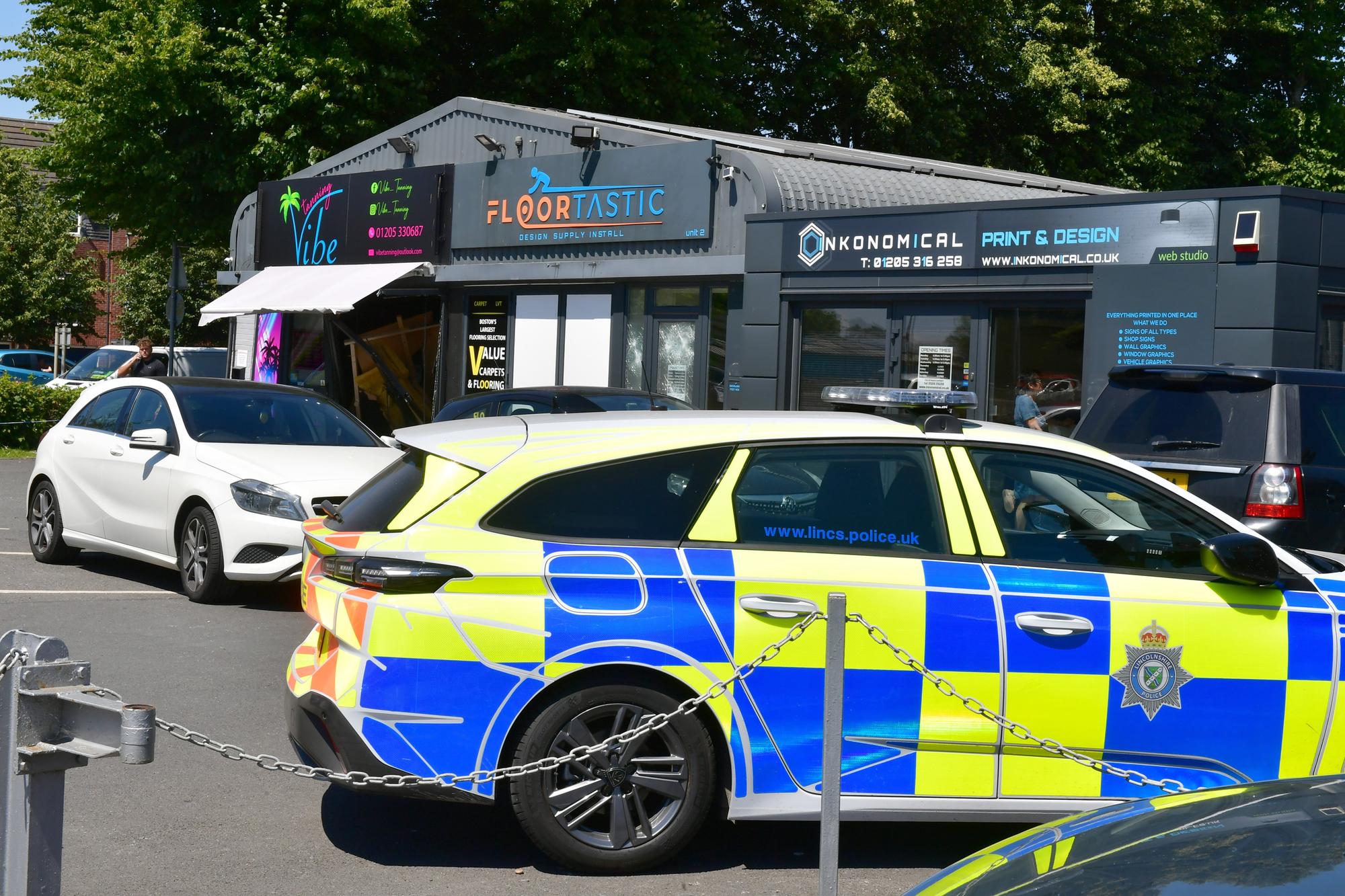 Police on the scene after a van crashed into a tanning salon on Nelson Way in Boston on Monday night. Photo: David Dawson
