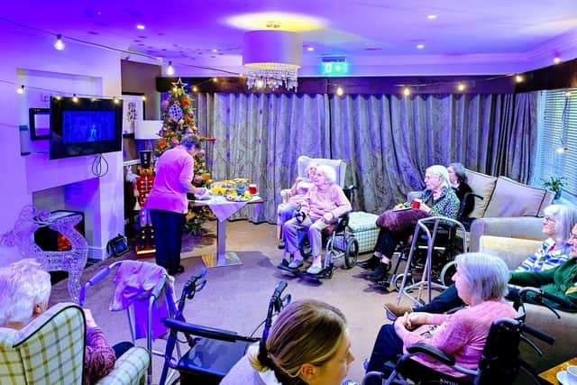 residents and guests enjoying a Christmas Carol from the Old Vic.