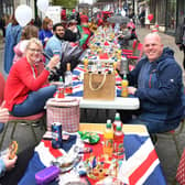 Cheers to the new King - the street party in Spilsby gets underway.