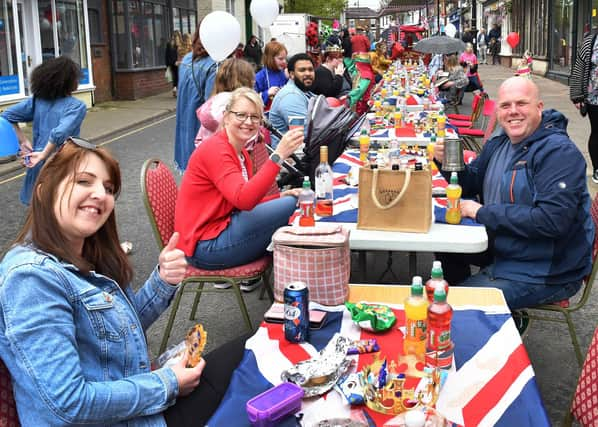 Cheers to the new King - the street party in Spilsby gets underway.