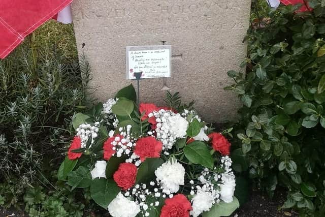 Local men David Harrigan and Brian Riley placed flowers and a banner at George's fathers' grave at RAF Coningsby.