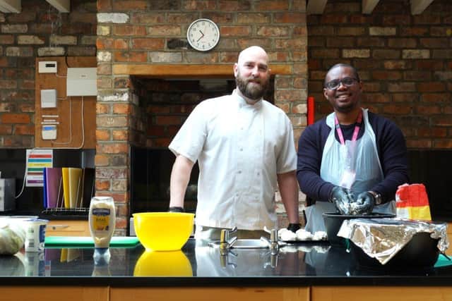 Chef Darren Hampton (left) of Home From Home Care leading cooking workshops for staff.
