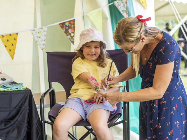 Darcey Barnes, aged 7, from William Alvey School getting (temporary!) body art by Felicity. Photo: Holly Parkinson