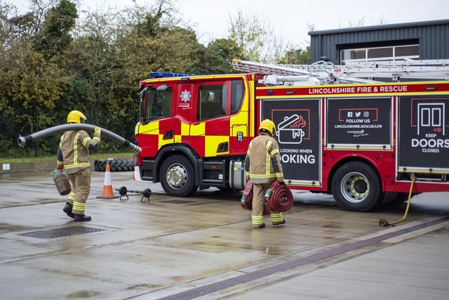 Carrying equipment to experience what firefighting is like. Photo: Holly Parkinson