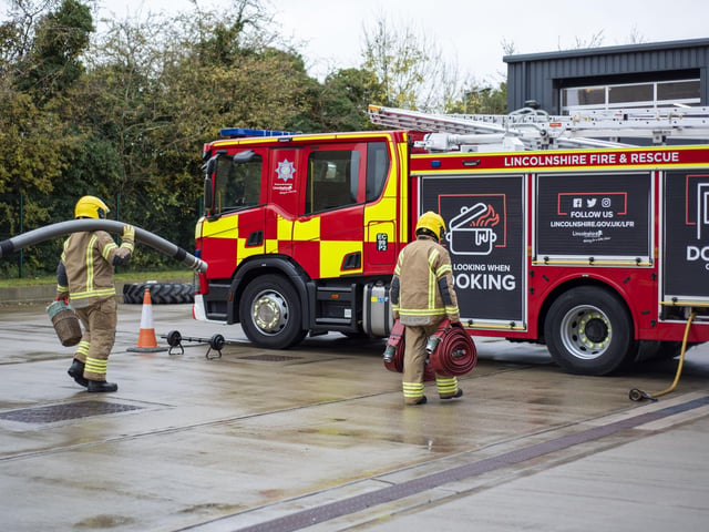 Carrying equipment to experience what firefighting is like. Photo: Holly Parkinson