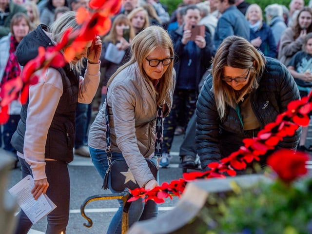People placing candles at the war memorial in Louth.