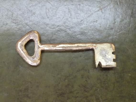 A brass replica of the key found in excavations at Sleaford castle site.