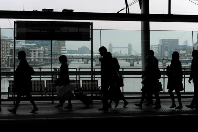 Commuters make their way across the platform at Blackfriars Station, London, in the morning rush hour.