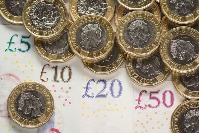 File photo dated 26/01/18 of UK five pound, ten pound, twenty pound and fifty pound notes with one pound coins, as the proportion of children living in families which could not afford essentials fell by a quarter in the six years before the coronavirus pandemic, research suggests.
