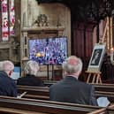 Parishioners observing the state funeral of HM The Queen at St Denys' Church on Monday.