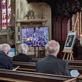 Parishioners observing the state funeral of HM The Queen at St Denys' Church on Monday.