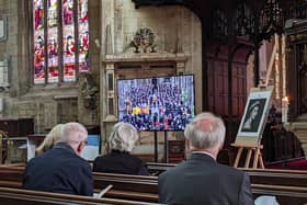 Parishioners observing the state funeral of HM The Queen at St Denys' Church on Monday.