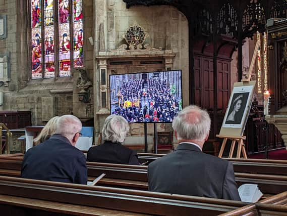 Parishioners observing the state funeral of HM The Queen at St Denys' Church on Monday.