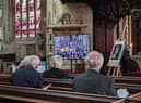 Parishioners observing the state funeral of HM The Queen at St Denys' Church on Monday.